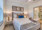 Thumbnail 7 of 50 - A bedroom with a large bed and a ceiling fan.