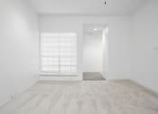 Thumbnail 17 of 33 - an empty room with a window and white walls