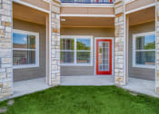 Thumbnail 39 of 65 - a front porch of a house with a red door