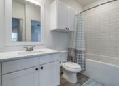 Thumbnail 34 of 65 - a bathroom with a white sink and toilet and a shower