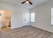 Thumbnail 32 of 65 - an empty living room with white walls and a ceiling fan