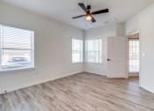 Thumbnail 30 of 65 - an empty room with colorful lights on the ceiling and a wooden floor
