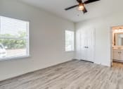 Thumbnail 35 of 65 - an empty living room with a ceiling fan and a window