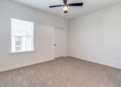 Thumbnail 14 of 65 - an empty living room with a ceiling fan and a window