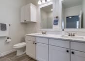 Thumbnail 20 of 65 - a bathroom with a sink and a mirror and a toilet