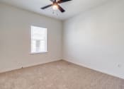 Thumbnail 10 of 65 - an empty room with a ceiling fan and a window