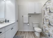 Thumbnail 19 of 65 - a bathroom with white cabinets and a toilet and a sink