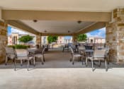 Thumbnail 51 of 65 - a covered patio with tables and chairs