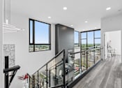 Thumbnail 19 of 35 - A modern interior with a staircase leading to the upper floor.