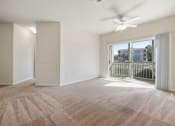 Thumbnail 7 of 30 - A room with a carpeted floor and a ceiling fan.