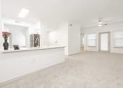 Thumbnail 4 of 41 - an empty living room and kitchen with white walls and flooring