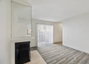 Thumbnail 17 of 34 - an empty living room with a fireplace and a window