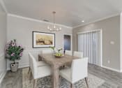 Thumbnail 11 of 22 - A dining room with a wooden table and chairs.