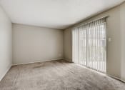Thumbnail 24 of 36 - a bedroom with a large window and a carpeted floor