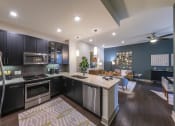 Thumbnail 1 of 30 - a kitchen with a large center island next to a living room with a couch