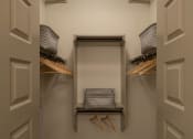 Thumbnail 8 of 30 - a walk in closet with white walls and two white doors