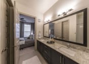 Thumbnail 6 of 30 - a bathroom with a large mirror and a sink