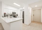 Thumbnail 7 of 41 - a white kitchen with a white counter top and a sink