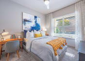 Thumbnail 6 of 22 - a bedroom with a bed and a desk and a window