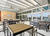 Thumbnail 13 of 31 - A patio with a table and chairs is shown.