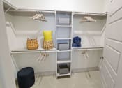 Thumbnail 16 of 36 - a walk in closet with white shelves and a closet organizer