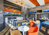 Thumbnail 25 of 36 - a lounge area with chairs and tables and a fireplace