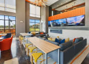 Thumbnail 26 of 36 - a lounge area with couches tables and chairs and large windows