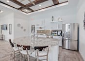 Thumbnail 11 of 23 - a kitchen with a marble counter top and stainless steel appliances