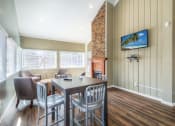 Thumbnail 14 of 16 - a dining room with a table and chairs and a fireplace
