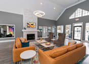 Thumbnail 3 of 31 - a living room with couches and chairs and a fireplace