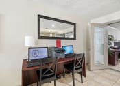 Thumbnail 31 of 34 - a home office with a desk with three computers on it