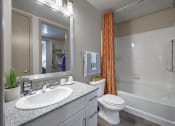 Thumbnail 7 of 22 - a bathroom with a shower toilet and sink and a mirror