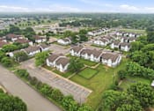 Thumbnail 24 of 27 - A bird's eye view of a residential area with houses and a parking lot.