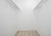 Thumbnail 20 of 33 - an empty room with white walls and two white shelves