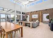 Thumbnail 2 of 31 - A modern office space with a long wooden table and chairs, a couch, and a reception desk with a sign that reads "RESIA".