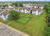 Thumbnail 18 of 27 - A large grassy area in front of apartment buildings.