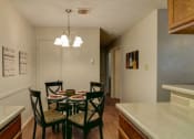 Thumbnail 4 of 8 - a kitchen and dining room with a table and chairs