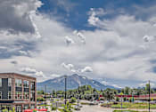 Thumbnail 22 of 22 - a view of a mountain and a parking lot with a building in the foreground