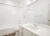 Thumbnail 21 of 33 - a bathroom with a sink and a toilet and a shower