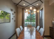 Thumbnail 19 of 30 - a dining room with a long table and chairs and a chandelier