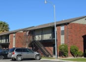 Thumbnail 5 of 8 - a car parked in front of a brick building