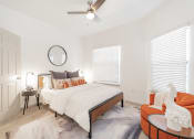 Thumbnail 7 of 20 - a bedroom with a large bed and a ceiling fan