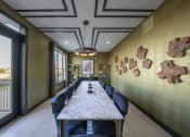 Thumbnail 14 of 30 - a long table with chairs and a painting on the wall
