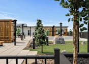 Thumbnail 12 of 35 - A modern building with a wooden fence and a tree in front.