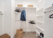 Thumbnail 11 of 20 - a walk in closet with white shelves and a closet organizer