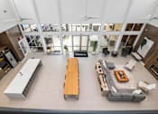 Thumbnail 6 of 31 - A modern living room with a long wooden table and a sofa.