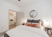 Thumbnail 8 of 20 - a bedroom with a bed and a closet and a mirror
