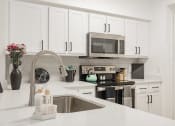 Thumbnail 1 of 41 - a modern kitchen with white cabinets and a sink