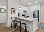 Thumbnail 5 of 47 - A kitchen with a white countertop and black barstools.