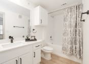 Thumbnail 35 of 41 - a bathroom with a shower and a toilet and a sink
